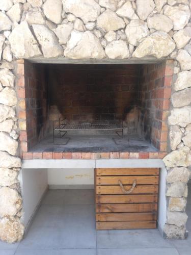 a stone fireplace in a brick wall at Atlantic Sands Beachfront Estate in Velddrif