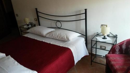a bedroom with a bed with a red blanket at Residenza Le Volte Degli Angeli in Spello