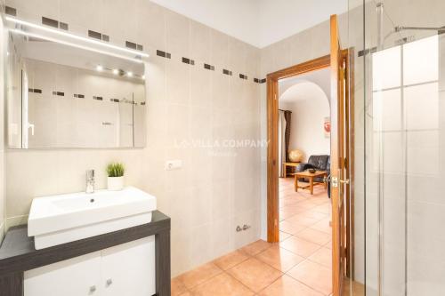 a bathroom with a sink and a shower at Villa OCEANA in Cala en Porter