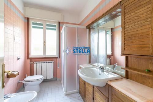 a bathroom with a sink and a toilet at Casa Rialto in Lido di Jesolo
