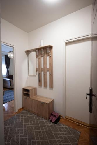 a room with a closet and a door with a mirror at Apartmani Dambo in Kraljevo