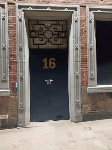 a black door with the number on it at Queens Hotel in Blackburn