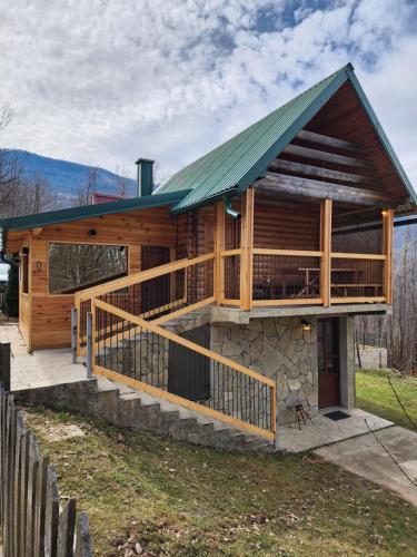 a large log cabin with a green roof at Koliba Pčelica 1-SPA in Bijelo Polje