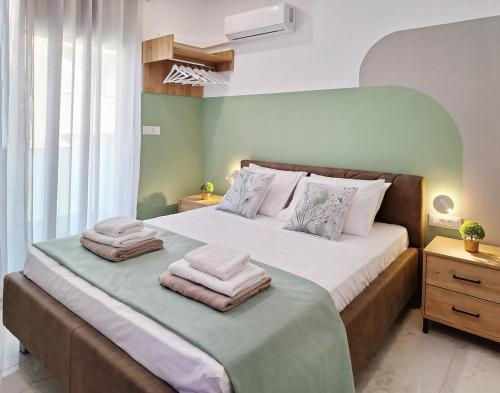 a bedroom with a large bed with towels on it at Coastal Ierapetra 1 in Ierapetra