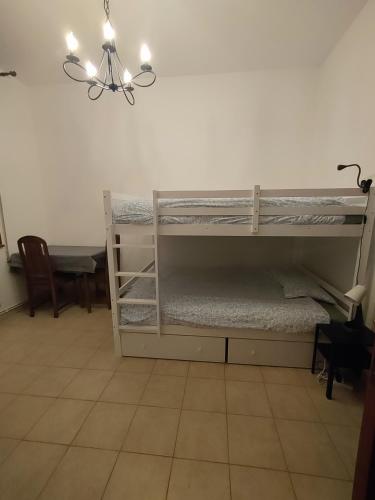 a room with two bunk beds and a table at Belemi's House 