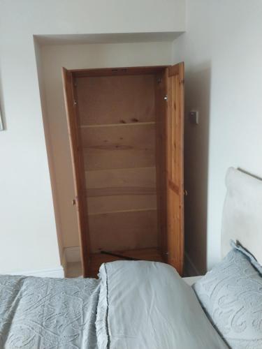 a bedroom with a closet with a bed in it at Queens Hotel in Blackburn