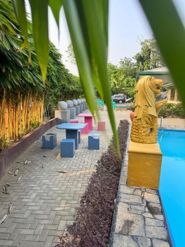 a statue of a lion next to a pool at Resolve Garden Hotel in Dodangoda