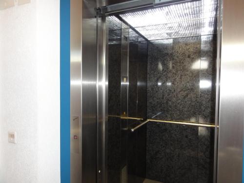 a shower with a glass door in a bathroom at Helvetia Apartments in Saas-Fee