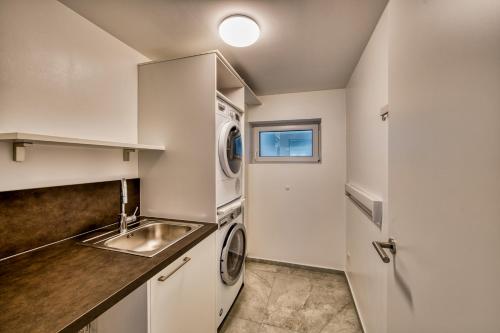a kitchen with a sink and a washing machine at Premium Apartment zentrumsnah in Aschaffenburg