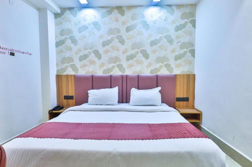 a bedroom with a large bed with a purple headboard at Orsom Stays Sassy Sector 53 in Gurgaon
