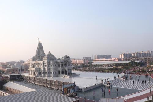 a building in a city with people walking around it at Hotel Prem Inn in Vrindāvan