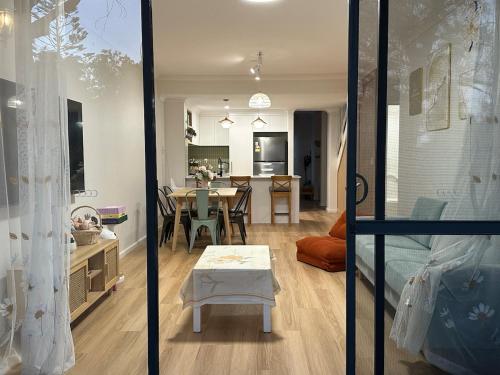 a living room with a table and a dining room at Koombana Bay beach Homestay in Bunbury