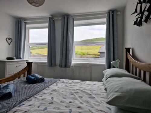 En eller flere senge i et værelse på Old Bakery Cottage