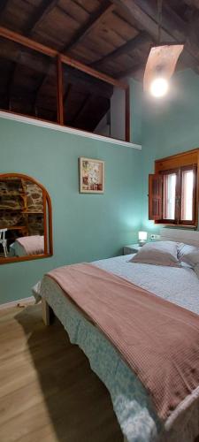 a bedroom with a bed in a room at Casa dos ánxeles VUT-OR-1310 in Trasmiras