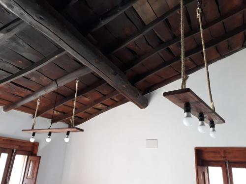 a group of lights hanging from a ceiling at Casa dos ánxeles VUT-OR-1310 in Trasmiras