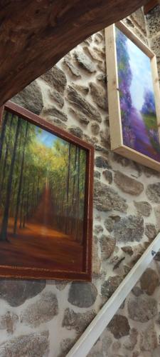 a painting of a forest on a stone wall at Casa dos ánxeles VUT-OR-1310 in Trasmiras