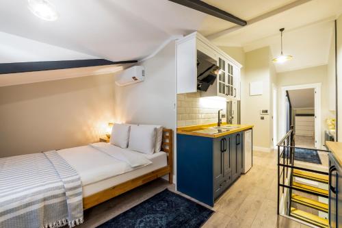 a small bedroom with a bed and a sink at Respiro Rooms in Istanbul