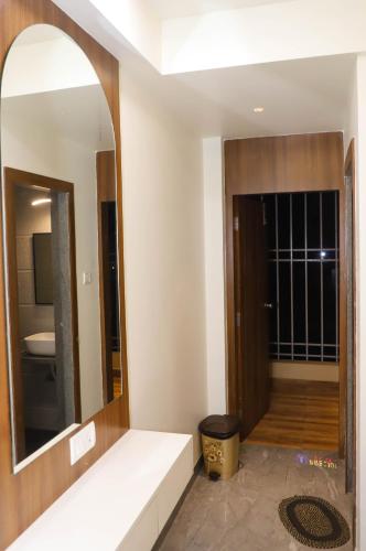 a bathroom with a large mirror and a room at Hotel PNP Royal in Amarnāth