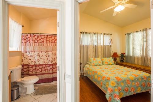 a bedroom with a bed and a toilet at The Dolphin Cottage at Kehena Beach in Kehena