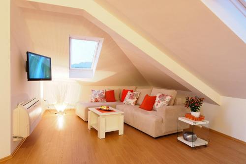 a living room with a couch and a tv at Apartments Anuška in Cavtat