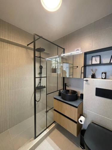 a bathroom with a sink and a glass shower at Seaview City Retreat in Larnaca