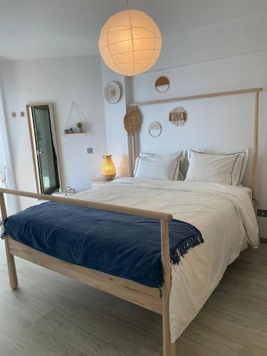 a bedroom with a large bed with a blue blanket at Seaview City Retreat in Larnaca