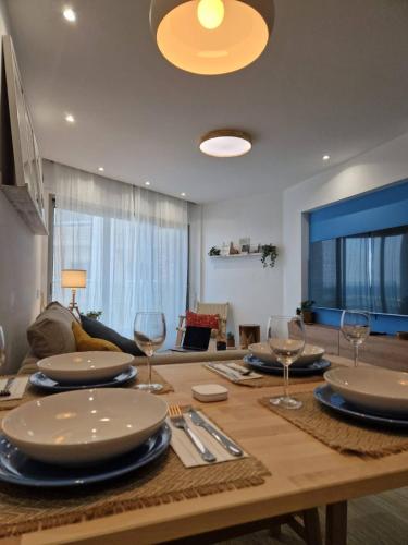 a dining room table with plates and wine glasses at Seaview City Retreat in Larnaca
