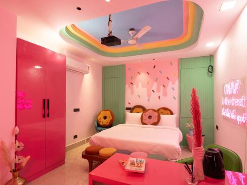a childs bedroom with a bed and a rainbow ceiling at Orsom Stays Sassy Sector 53 in Gurgaon