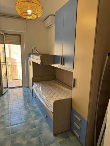 a room with a bunk bed in a kitchen at Sabina's House in Acciaroli