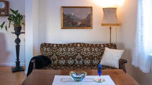 a living room with a couch and a table at Charming house with exceptional view in Vestvågøya