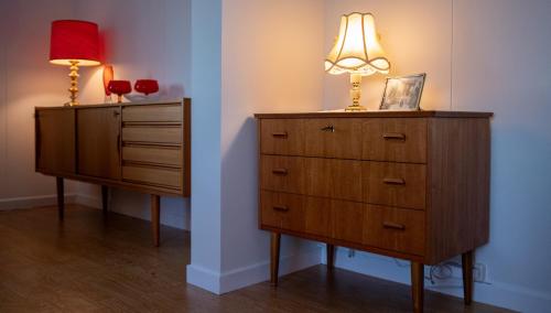 a bedroom with a dresser and a lamp on top at Charming house with exceptional view in Vestvågøya