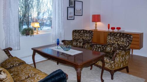 a living room with a coffee table and a couch at Charming house with exceptional view in Vestvågøya