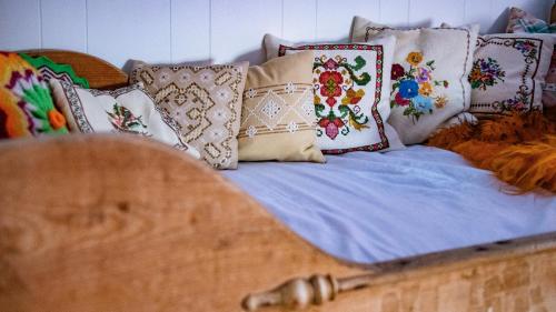 a bed with a bunch of pillows on it at Charming house with exceptional view in Vestvågøya