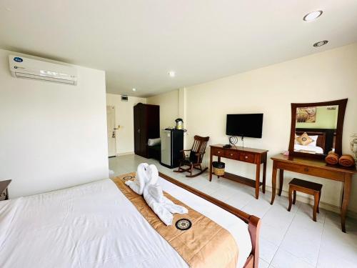 a hotel room with a bed with a towel on it at Sea Boss Homestay in Kata Beach