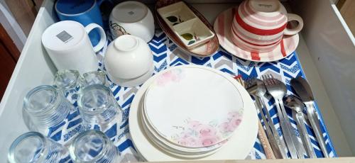 a table with a plate and glasses on it at Chic and Affordable Studio in Davao City
