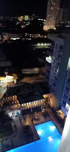 a view of a building with a swimming pool at night at Chic and Affordable Studio in Davao City