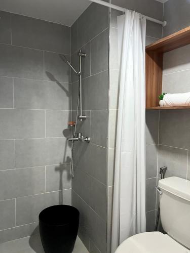 a bathroom with a shower with a toilet at J Tower Residences in Mandaue City