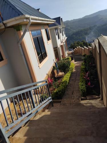 a stairway leading to a house with a balcony at Sweetland view hotel in Lushoto