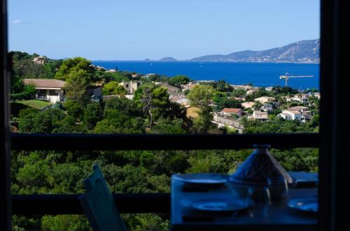 a view of the ocean from a window at Duplex 2 chambres, vue mer & balcon - 6 couchages in Porticcio