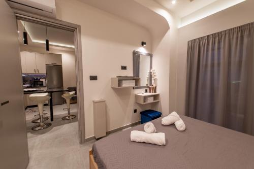 a bedroom with a bed with two towels on it at St Paul 25 Urban Apts in Kos Town