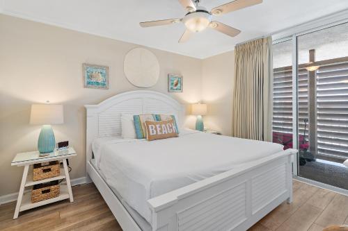 a white bedroom with a white bed and a window at Magnolia House 504 At Destin Pointe Resort in Destin