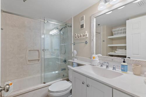 a bathroom with a shower and a toilet and a sink at Magnolia House 504 At Destin Pointe Resort in Destin