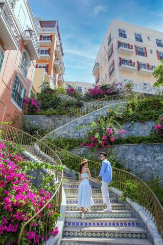 a man and a woman standing on some stairs at Sun Bay Hotel Phu Quoc in Phu Quoc