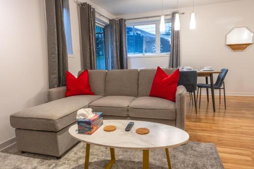 a living room with a couch and a table at Modern 3BR 4beds apartment AC WiFi Free Parking in Laval
