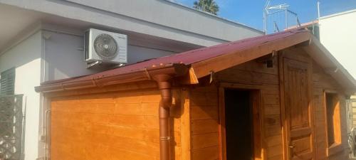 a porch of a house with a heater on the roof at Casa Delle Rose, struttura con parcheggio privato in Porto Cesareo