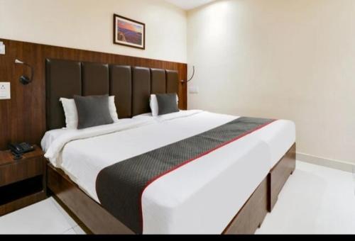 a bedroom with a large bed in a room at Hotel KGB Coolriver in Visakhapatnam