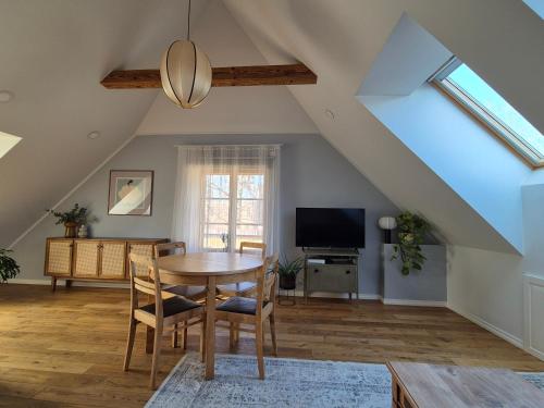 a dining room with a table and a tv at Home away home in Tartu