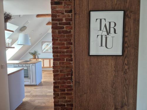 a door with a sign on it in a kitchen at Home away home in Tartu