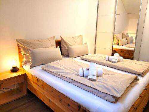 a bedroom with two beds and a mirror at Ferienwohnung Lindpointner in Innerschwand am Mondsee