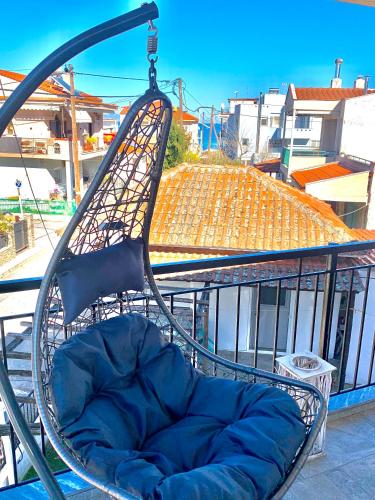 a chair sitting on top of a balcony at Zeffie's Studio in Olympiada